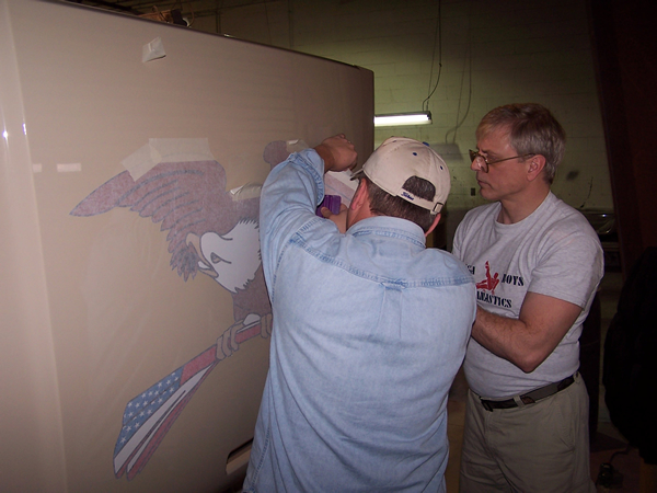 Mike and Jim applying Ian's Eagle design to the hood